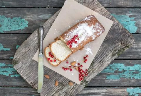Fruit cake with red currant and almond on a garden table Stock Photos