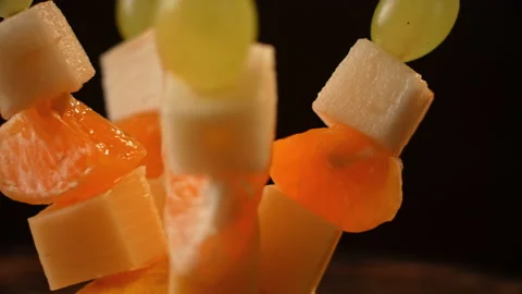 Fruit canapes, mini fruit canapes, pear, tangerine, grapes, cheese spinning Stock Footage 148622271