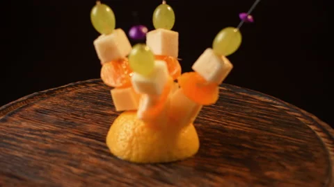 Fruit canapes, mini fruit canapes, pear, tangerine, grapes, cheese spinning Video stock 148623912