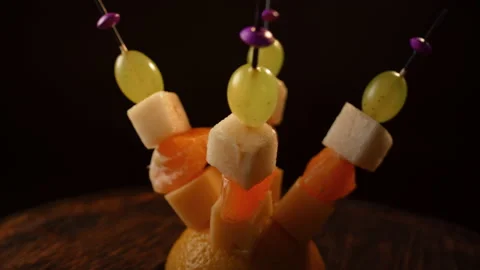 Fruit canapes spinning, mini fruit canapes, pear, tangerine, grapes, cheese Stock Footage 148620553