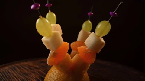 Fruit canapes spinning, mini fruit canapes, pear, tangerine, grapes, cheese Stock Footage 148620574