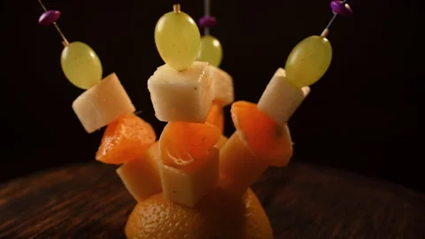 Fruit canapes spinning, mini fruit canapes, pear, tangerine, grapes, cheese Video stock 148620934