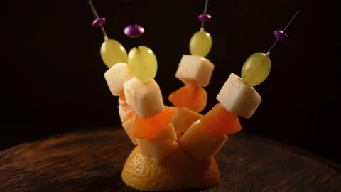 Fruit canapes spinning, mini fruit canapes, pear, tangerine, grapes, cheese Stock Footage 148622931