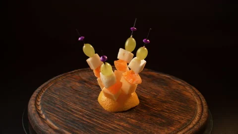 Fruit canapes spinning, mini fruit canapes, pear, tangerine, grapes, cheese Stock Footage 148624153
