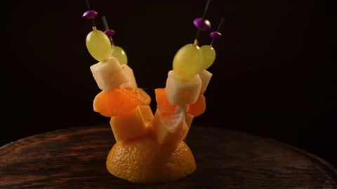 Fruit canapes spinning, mini fruit canapes, pear, tangerine, grapes, cheese Video stock 148627675