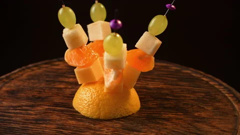 Fruit canapes spinning, mini fruit canapes, pear, tangerine, grapes, cheese Stock Footage 148630491