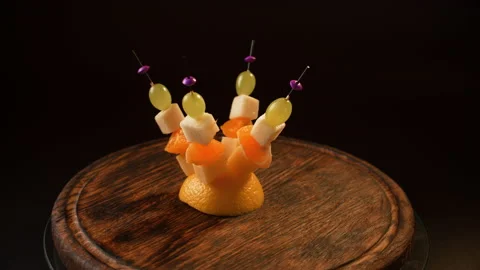 Fruit canapes spinning, mini fruit canapes, pear, tangerine, grapes, cheese Stock Footage 148631552