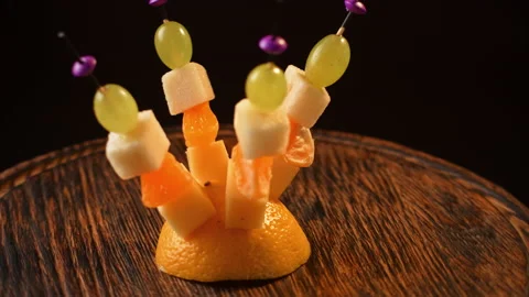 Fruit canapes spinning, mini fruit canapes, pear, tangerine, grapes, cheese Video stock 148634118