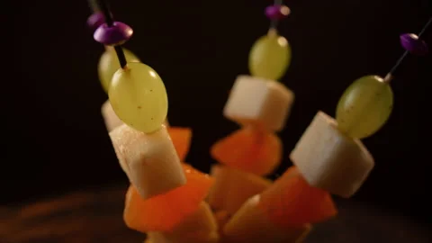 Fruit canapes spinning, mini fruit canapes, pear, tangerine, grapes, cheese Stock Footage 148639679