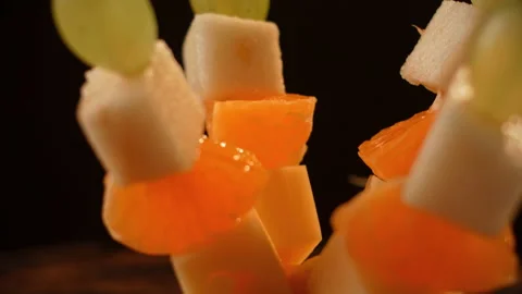 Fruit canapes spinning, mini fruit canapes, pear, tangerine, grapes, cheese Video stock 148642396