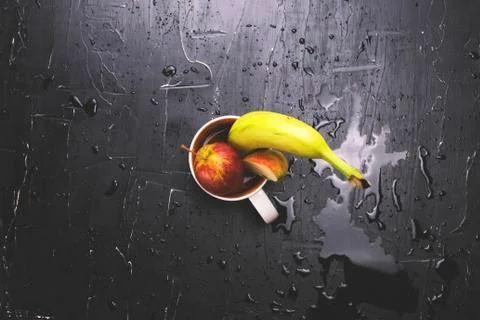 Fruit in a circle on a dark background. Concept of fresh juice and fruit tea Stock Photos