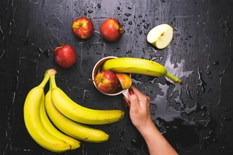 Fruit in a circle on a dark background. Concept of fresh juice and fruit tea Stock Photos