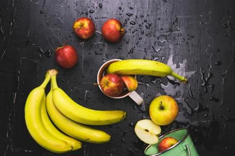 Fruit in a circle on a dark background. Concept of fresh juice and fruit tea Stock Photos