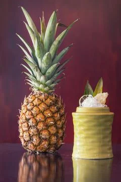 Fruit cocktail next to a pineapple Stock Photos