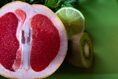 Fruit composition of cut red orange, lime, kiwi and verdure Stock Photos