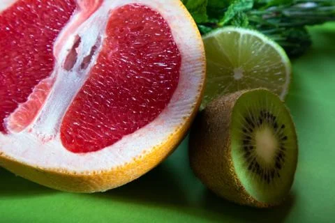 Fruit composition of cut red orange, lime, kiwi and verdure Stock Photos
