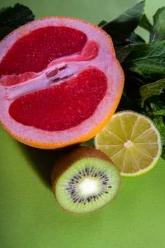 Fruit composition of cut red orange, lime, kiwi and verdure Stock Photos