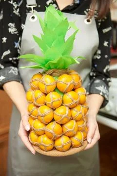 Fruit composition in the form of pineapple from tangerines for a gift Stock Photos