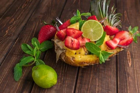 Fruit composition. Pineapple sliced in half with pineapple slices, strawberri Photos