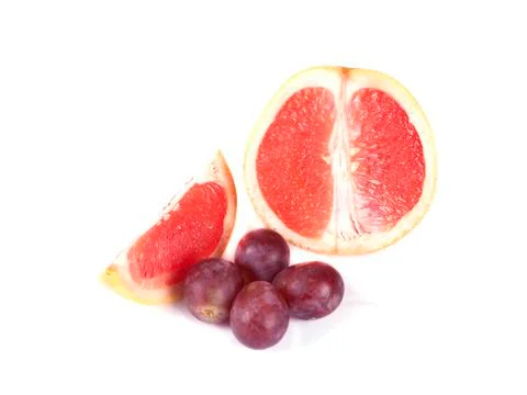 Fruit composition of ripe grapefruit and grapes Stock Photos