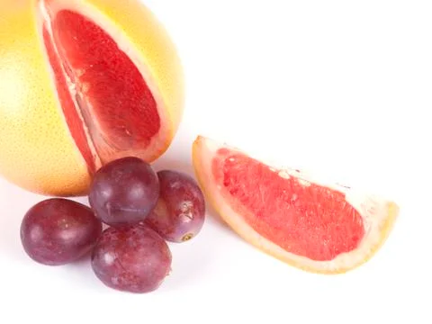Fruit composition of ripe grapefruit and grapes Stock Photos