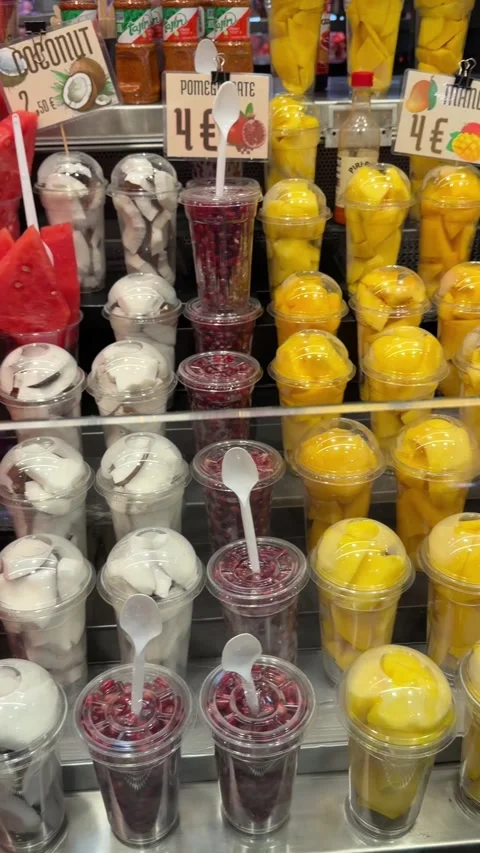 Fruit cups line market display in bright colors, with watermelon, mango, st.. Video stock 344736747