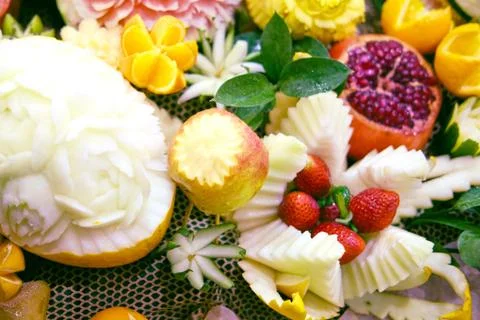 Fruit with a cut pattern in the form of flowers for holiday decoration 스톡 사진