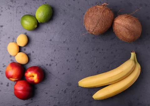 Fruit on dark stone surface Stock Photos