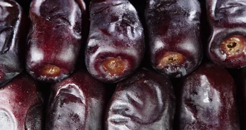 Fruit dates on a black background. Fresh dates slowly rotates. Macro dates fruit Stock Footage 151014230