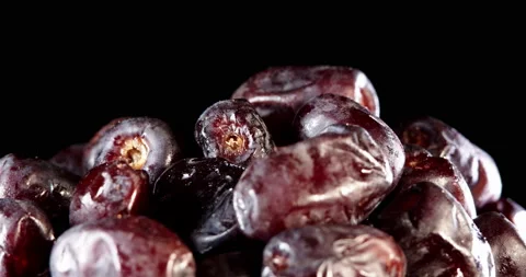 Fruit dates on a black background. Fresh dates slowly rotates. Stock Footage 151891232
