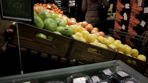Fruit department of the store, a loader with a trolley Stock Footage 128240741