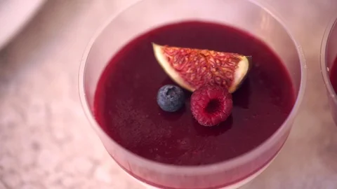 Fruit dessert, decorated with a slice of grapefruit, blueberries and raspberries 스톡 동영상 70754669