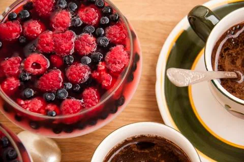 Fruit dessert with raspberry, blackberry and coffee of wooden table Stock Photos