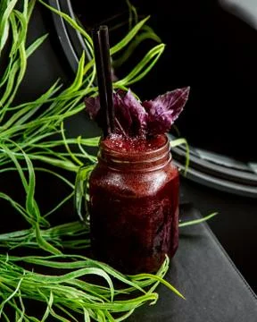 Fruit detox topped with basil Stock Photos