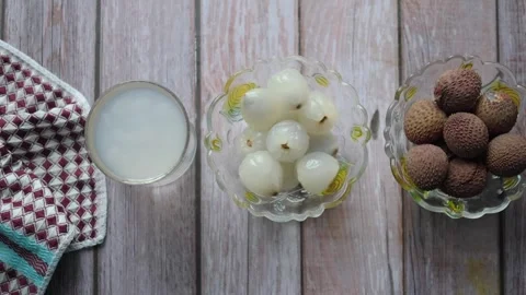 Fruit display with lychee and longan on a wooden table Stock Footage 337333902