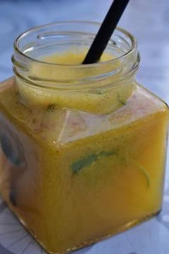 Fruit drink in the jar with straw on the table Stock Photos