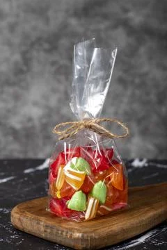 Fruit drops. Packed fruit flavored candy on a dark background Stock Photos