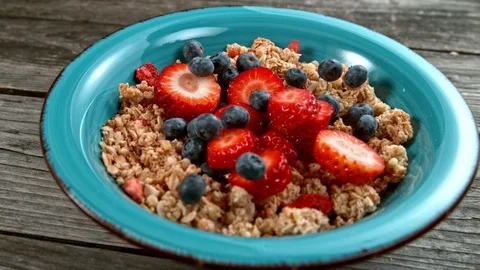 Fruit falling to cereals bowl in super slowmotion. Stock Footage 102551653