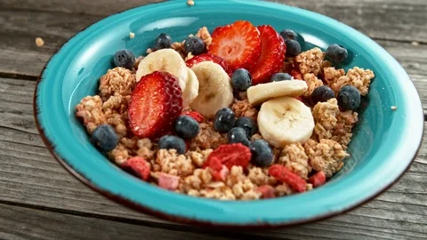 Fruit falling to cereals bowl in super slowmotion. Stock Footage 102551974