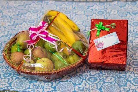 Fruit gift wrap filled with different fruits and gift pack from flat angle 写真素材