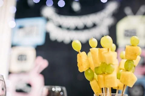 Fruit grape and pineapple snack on sticks Photos