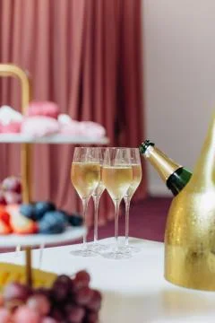 Fruit grapes marshmallows colored table set champagne Stock Photos