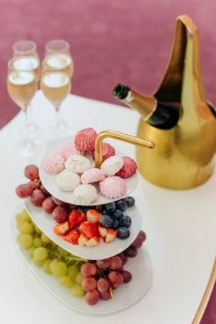 Fruit grapes marshmallows colored table set champagne Stock Photos