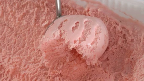 Fruit ice cream scooping out of container by metal spoon in slow motion Stock Footage 74409130