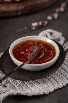 Fruit Jam in White Bowl on Rustic Tabletop with Pussy Willow Accents Stock Photos