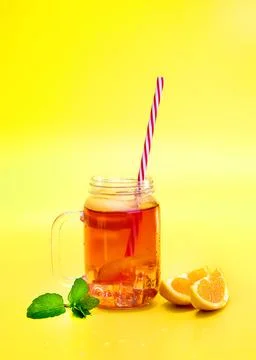 Fruit lemon orange tea with oranges on bright yellow background, refreshing Stock Photos