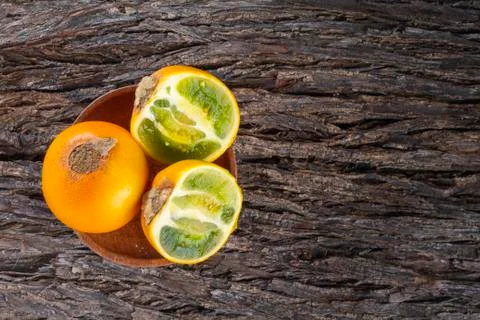 Fruit of lulo on tree bark (Solanum quitoense) Stock Photos