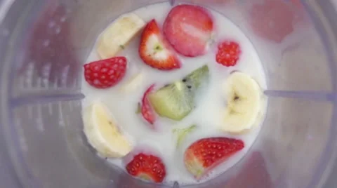 Fruit mix in a blender mixing slow motion Stock Footage