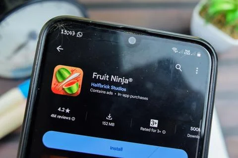 Fruit Ninja application on Smartphone screen. Fruit Ninja is a freeware web.. Stock Photos
