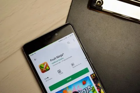 Fruit Ninja dev application on Smartphone screen. Photos